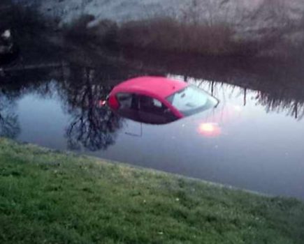 Car pushed into a canal in front of appalled owners